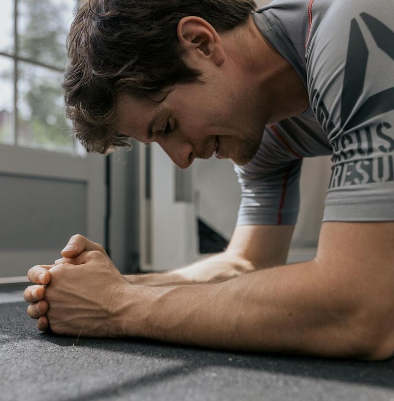Man in a plank position demonstrating core strength and stability.